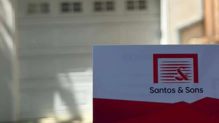 Santos & Sons business card at a Berkeley garage door repair job